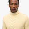 The Merchant Store – Jersey de cuello alto con trenzado