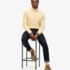 The Merchant Store – Jersey de cuello alto con trenzado